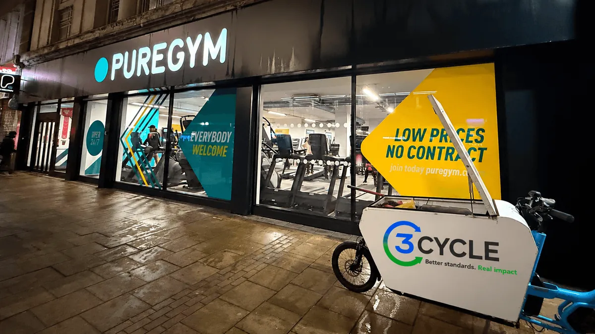 3Cycle cargo bike outside a PureGym shopfront at night